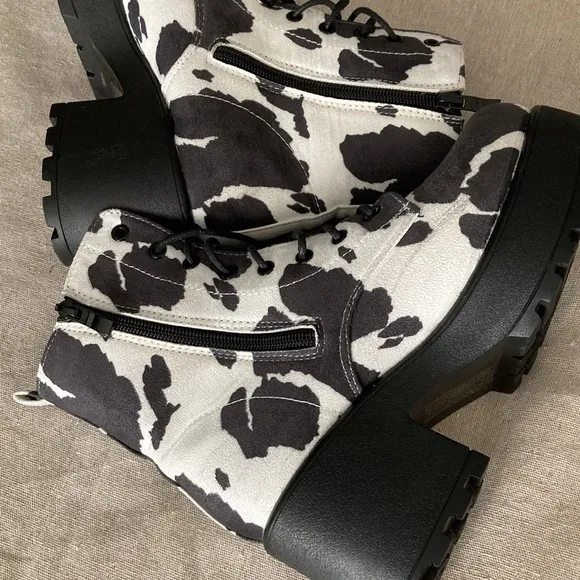 Hard to find faux suede caw print lace up and zipper boots.