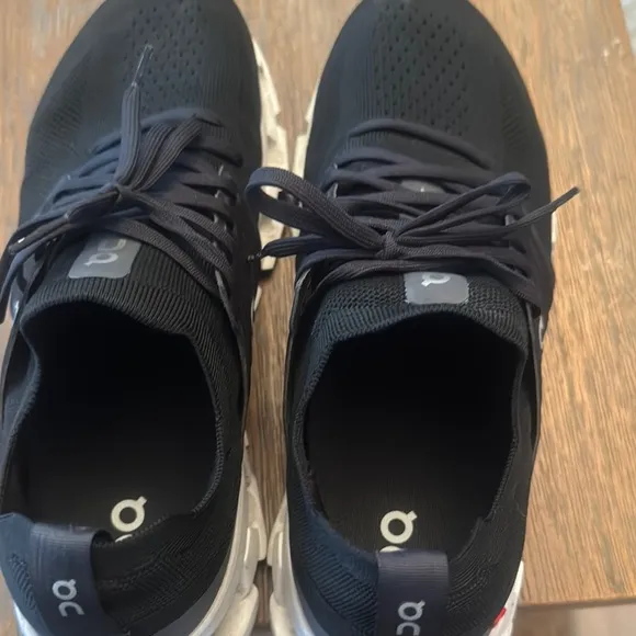 On Running Black and White Athletic Shoes with Cloud Cushioning