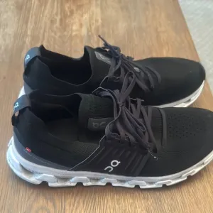 On Running Black and White Athletic Shoes with Cloud Cushioning
